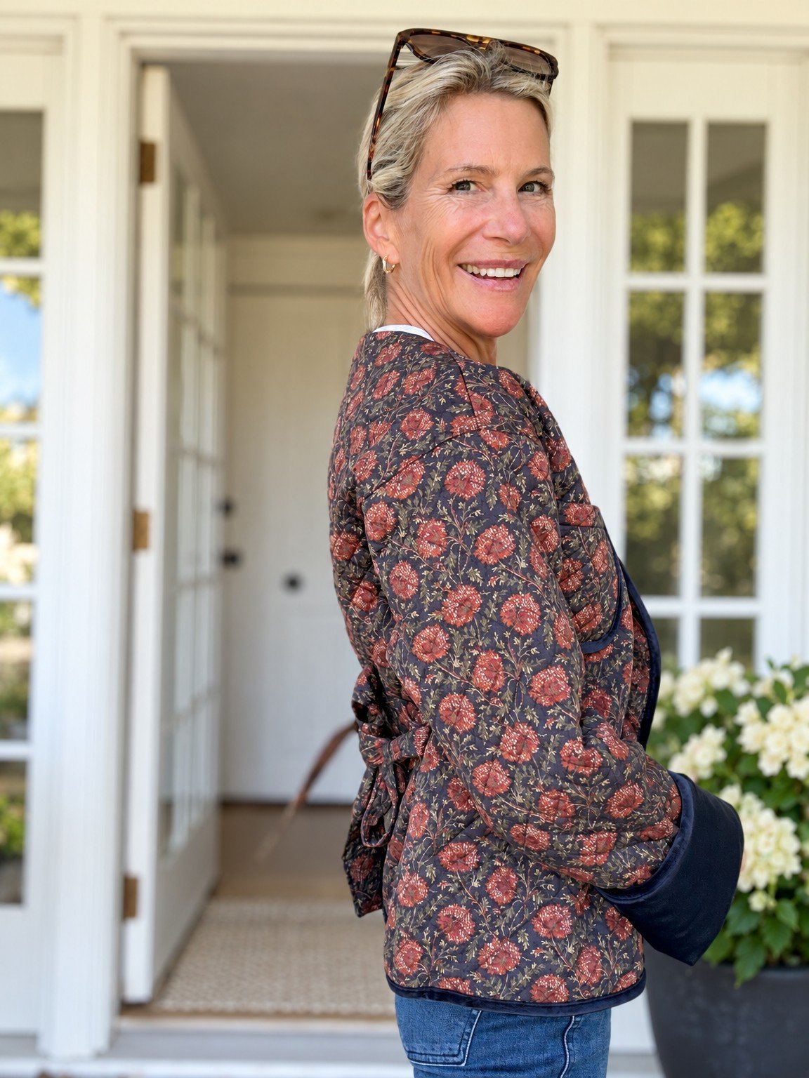 Angela in a dark floral quilted jacket with blue jeans.