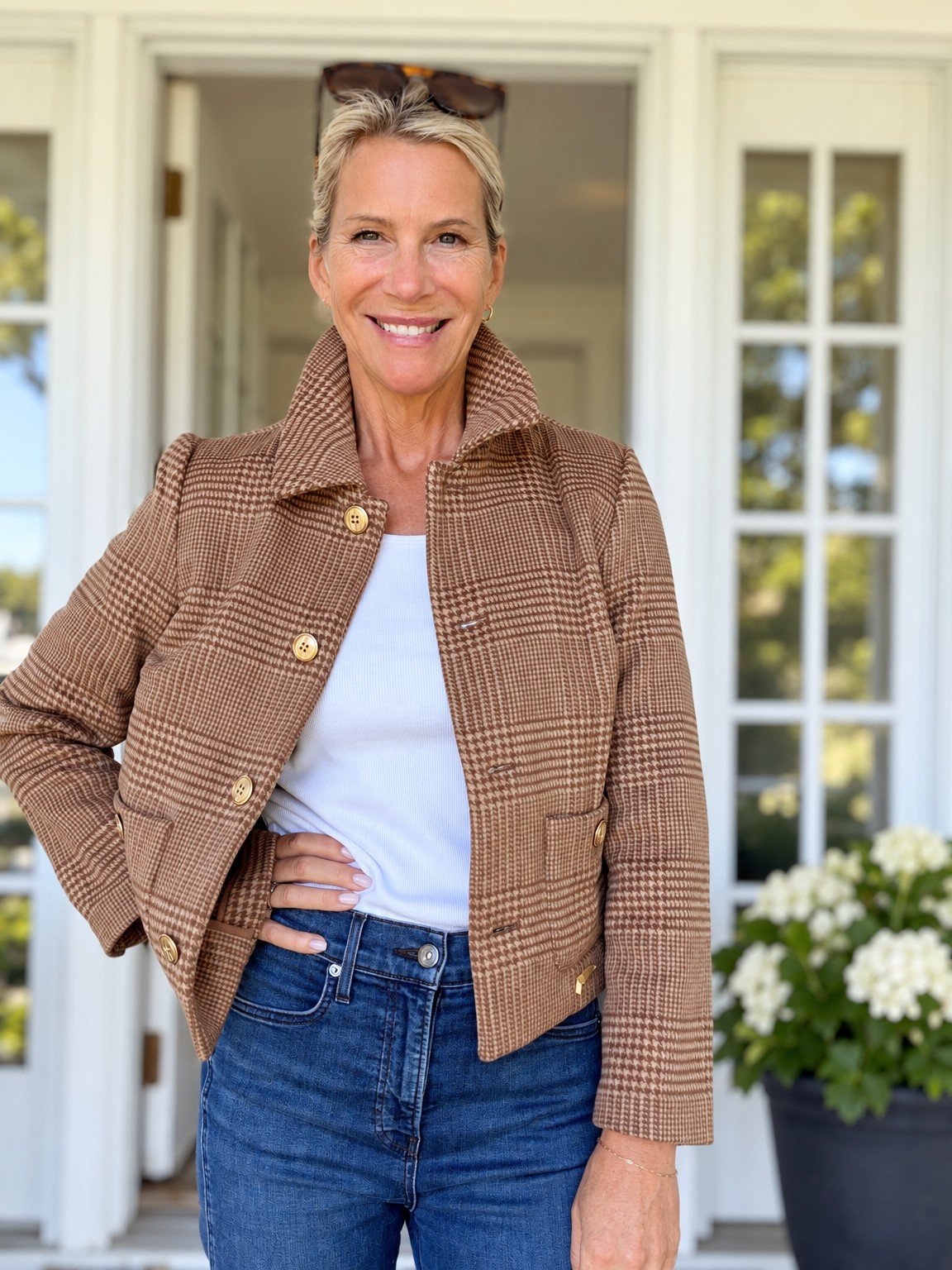 Angela in a tan plaid jacket over a white top and jeans.