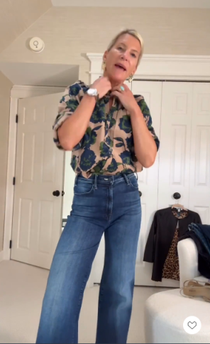 A blue and green floral blouse with wide-leg jeans.