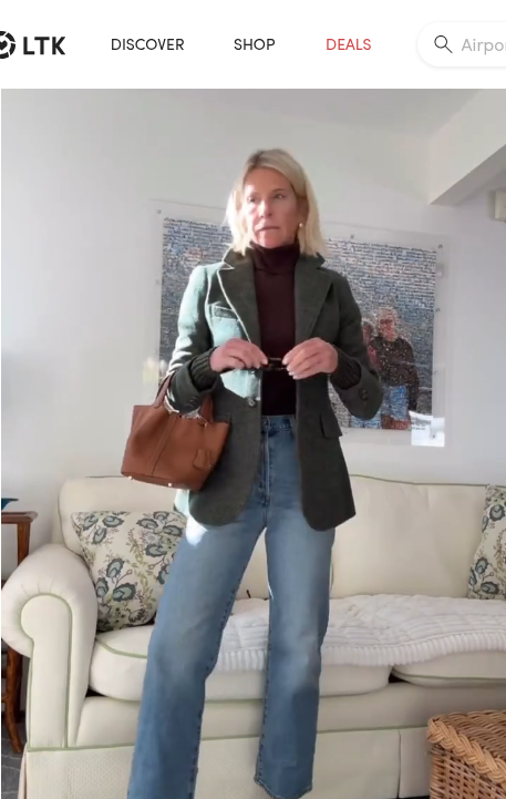 A blazer with knit cuffs paired with Levi’s jeans.