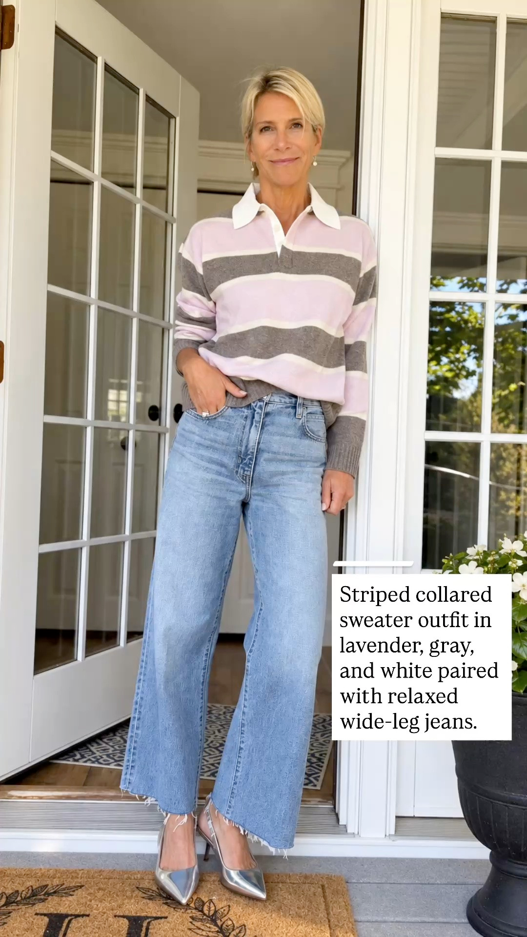 A lavender, gray, and white striped collared sweater with light wide-leg jeans.